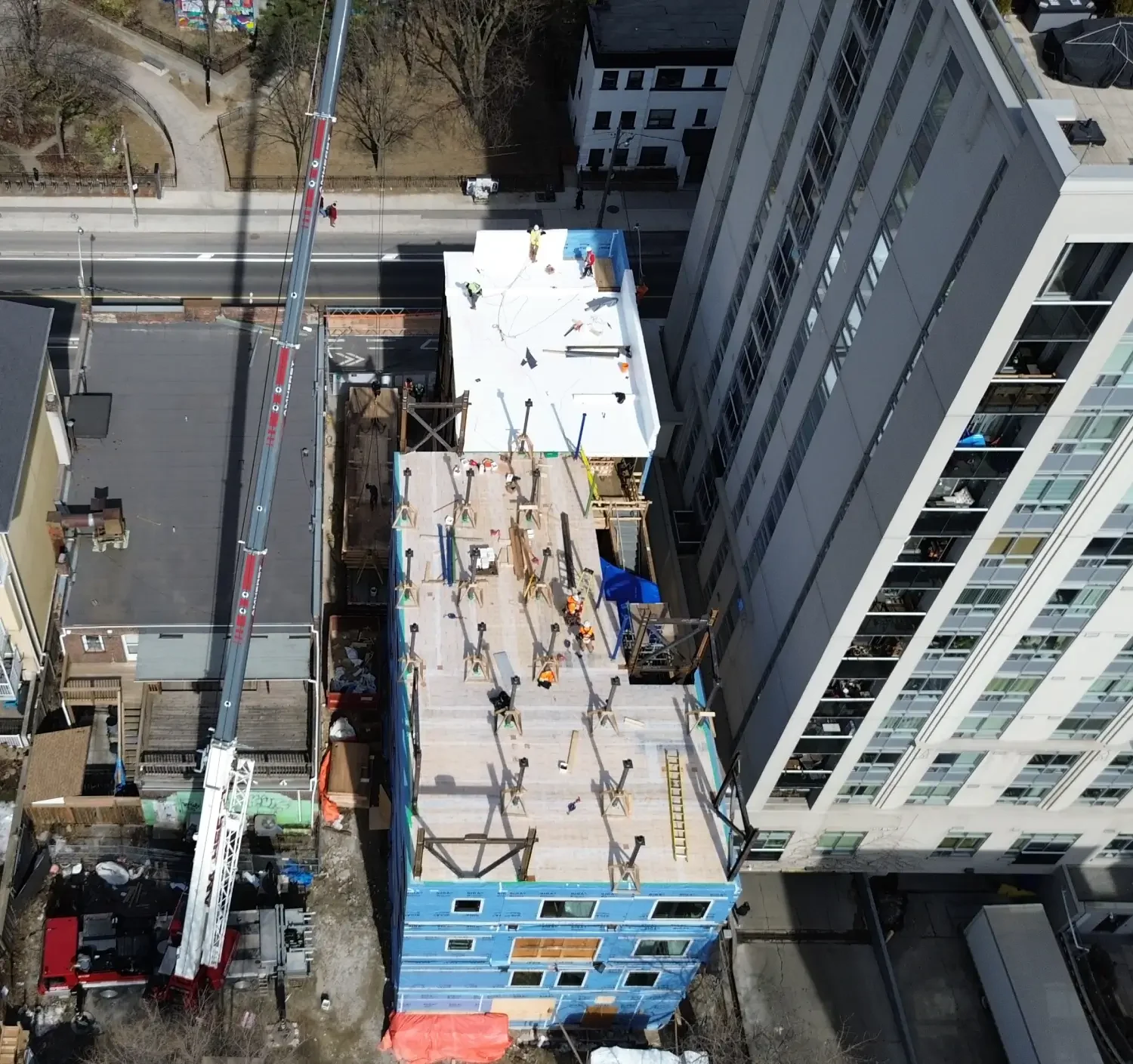 Aerial view of 215 Wellesley St, in-progress construction of an 8-storey infill transitional housing project.